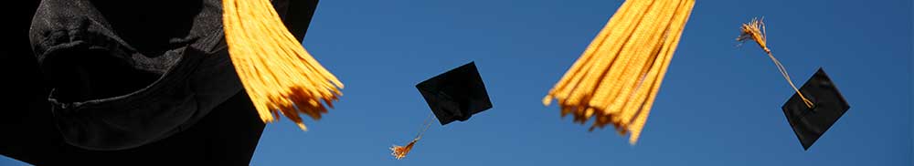 Picture - Graduation caps flying in the air